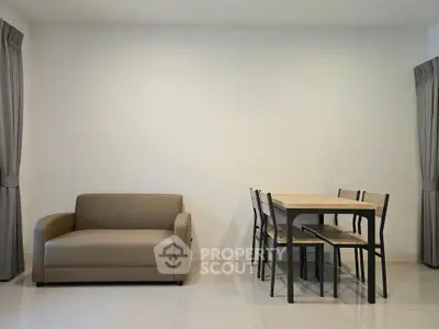 Modern minimalist living room with beige sofa and dining table set, perfect for cozy gatherings.