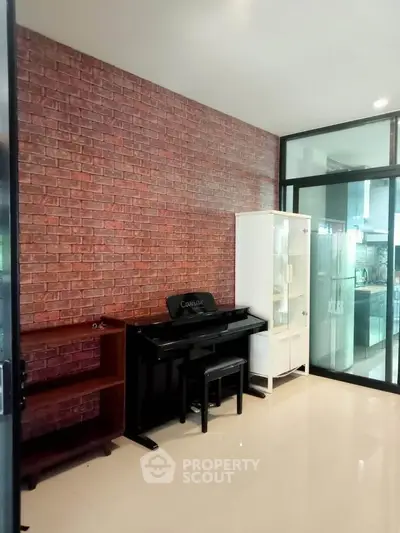 Stylish interior with brick accent wall and piano in modern living space.
