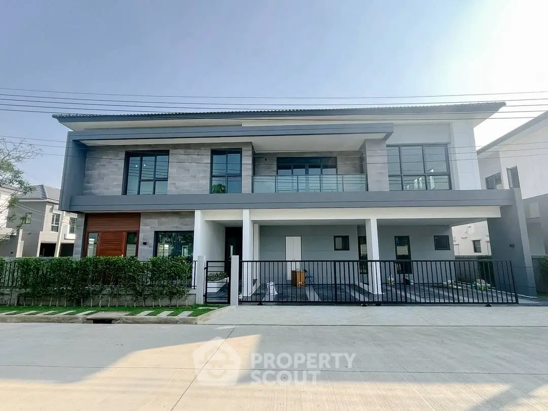 Modern two-story house with sleek design and spacious balcony in a serene neighborhood.