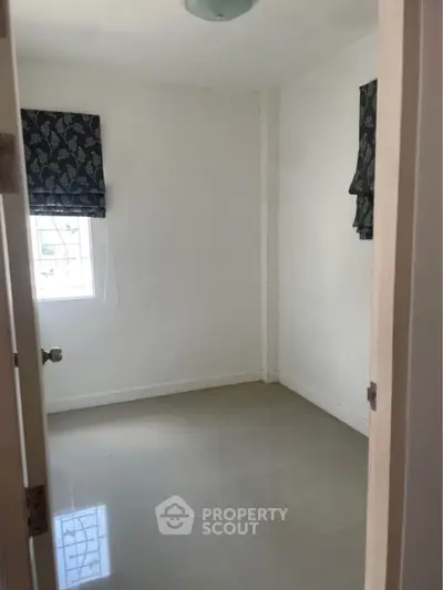 Minimalist empty room with tiled floor and window, perfect for customization.