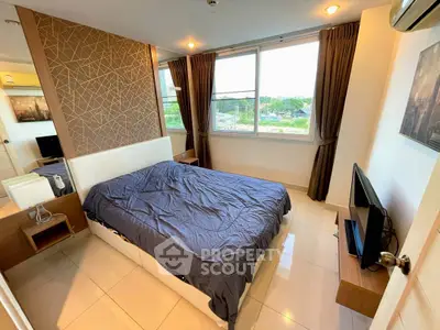 Modern bedroom with large window and stylish decor in a high-rise apartment.