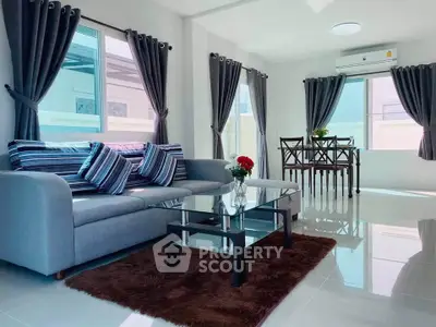 Bright and modern living room with stylish decor and dining area, perfect for comfortable living.