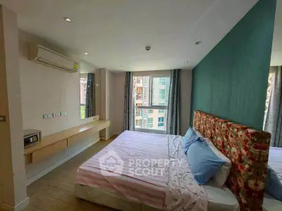 Spacious bedroom with modern decor and large window view