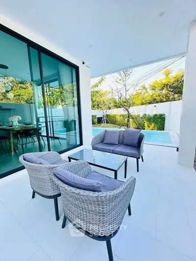 Luxurious outdoor patio with pool view and elegant seating area