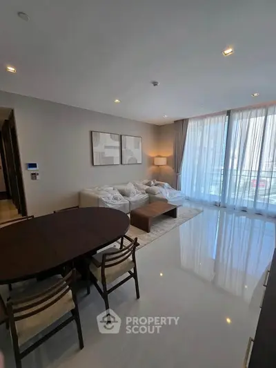 Spacious modern living room with elegant decor and large windows for natural light.