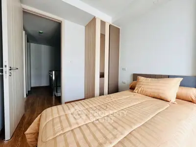 Modern bedroom with cozy bedding and sleek wardrobe design