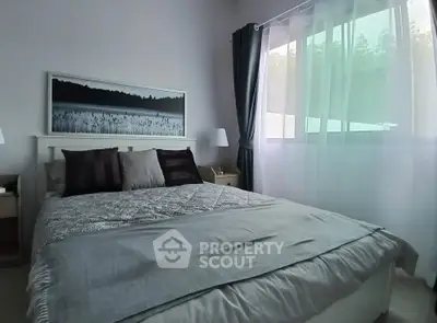 Cozy bedroom with large window and elegant decor in modern apartment