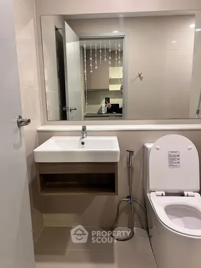 Modern bathroom with sleek fixtures and large mirror