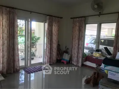 Spacious living room with large windows and garden view