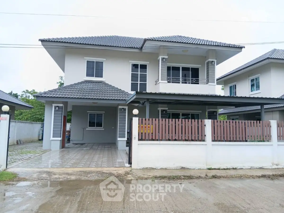 Modern two-story house with tiled roof and spacious driveway in suburban neighborhood.