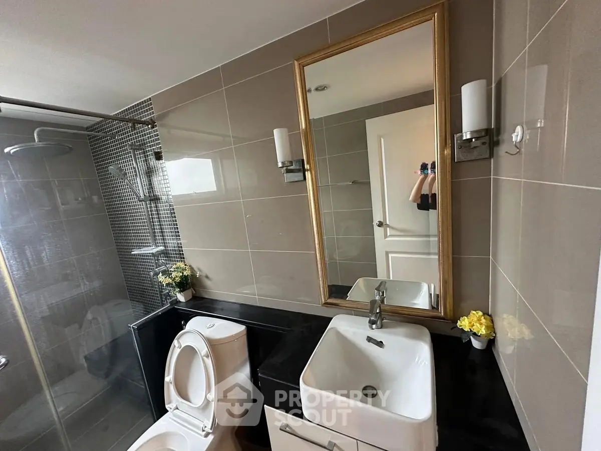 Modern bathroom with sleek fixtures and elegant mirror design