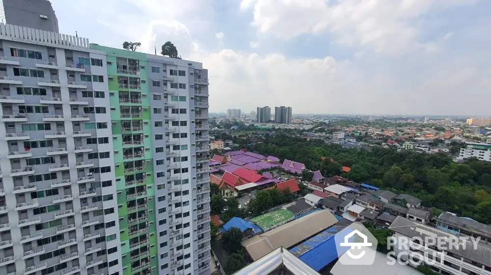 Stunning high-rise apartment view overlooking vibrant cityscape and lush greenery