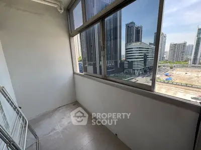 Urban balcony with city skyline view, perfect for relaxation and enjoying the vibrant cityscape.