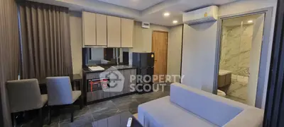 Modern living room with kitchenette and marble bathroom in stylish apartment