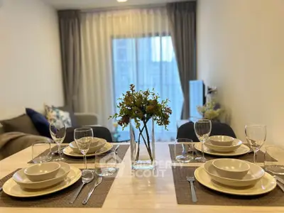 Elegant dining area setup with modern tableware and cozy living room view.