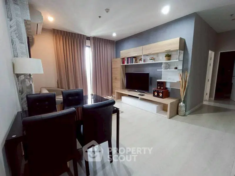 Modern living room with sleek furniture and entertainment center, perfect for relaxation and gatherings.