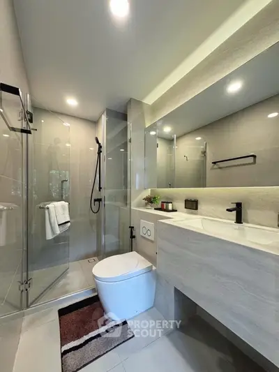 Modern bathroom with glass shower and sleek fixtures