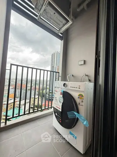 Modern balcony with washing machine and city view in high-rise apartment.