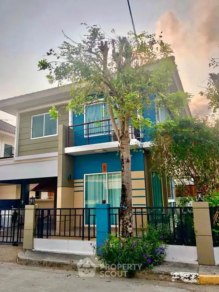 Charming two-story house with modern design and lush greenery in a serene neighborhood.