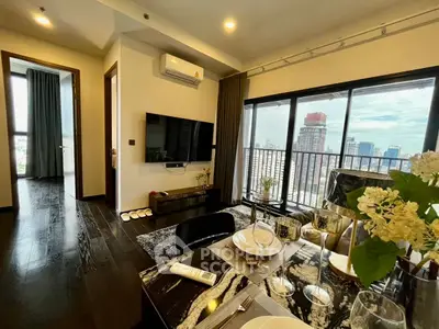 Modern living room with city view, stylish decor, and open layout dining area.