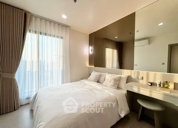 Modern bedroom with large window and stylish decor in a high-rise apartment.