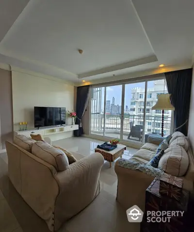 Spacious living room with large windows and city view in modern apartment