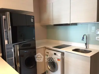 Modern kitchen with sleek appliances and compact design