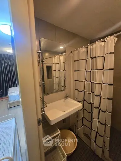 Modern bathroom with stylish shower curtain and sleek sink design