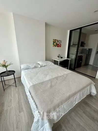 Modern bedroom with cozy bed and stylish decor in a contemporary apartment.