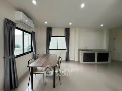 Modern open-layout kitchen and dining area with sleek design and natural light.