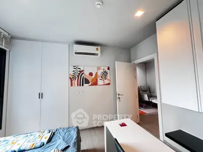 Modern bedroom with stylish decor and air conditioning in a contemporary apartment.