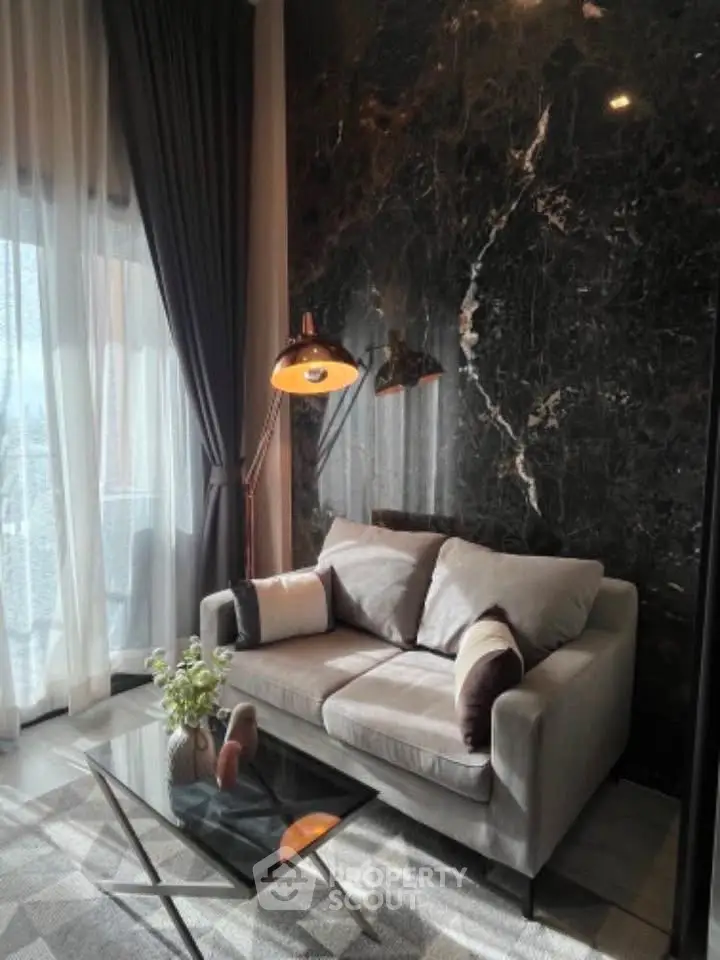 Luxurious living room with elegant marble wall and cozy sofa, perfect for relaxation.