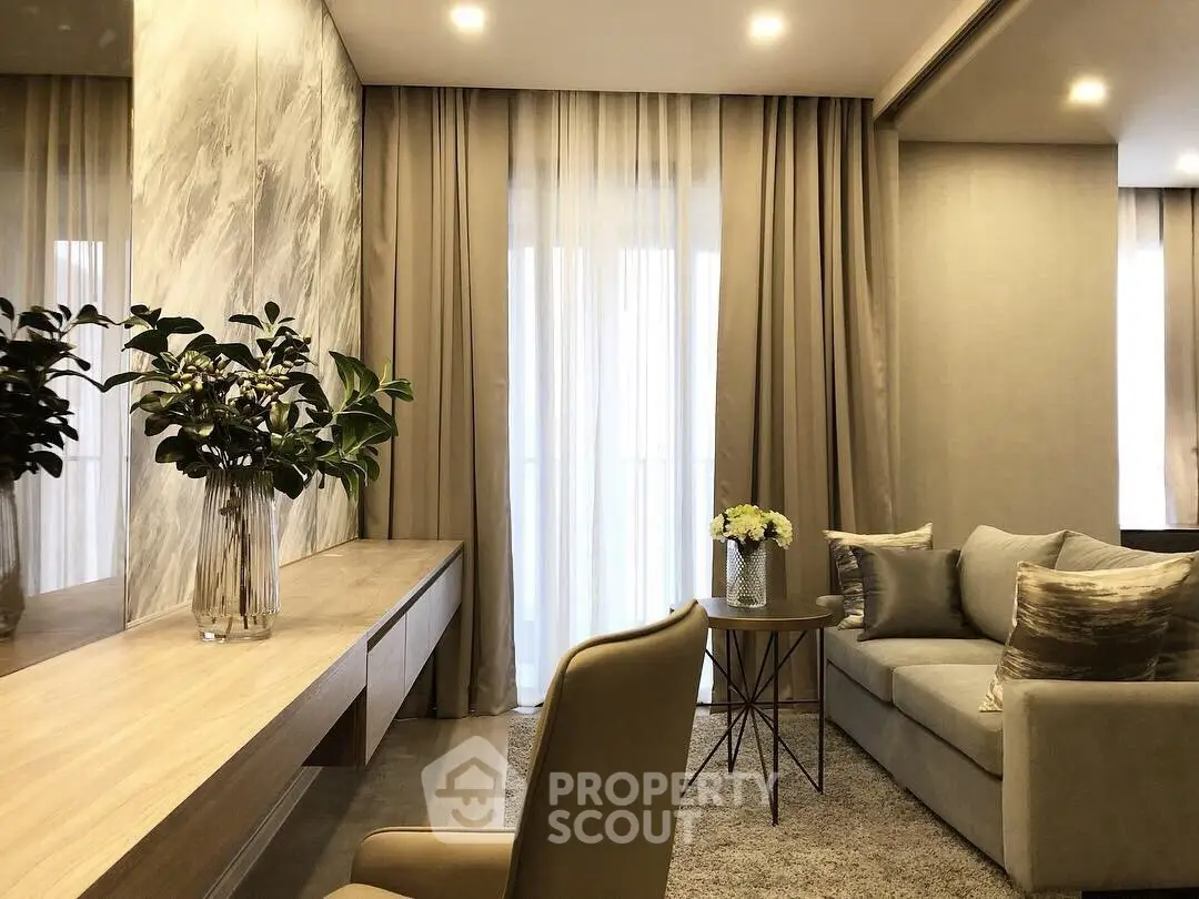 Elegant living room with modern decor, plush sofa, and floor-to-ceiling curtains.