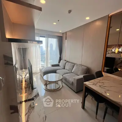 Modern living room with city view, featuring sleek furniture and marble accents, perfect for urban living.