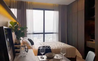 Modern bedroom with city view, featuring elegant decor and dining setup, perfect for urban living.
