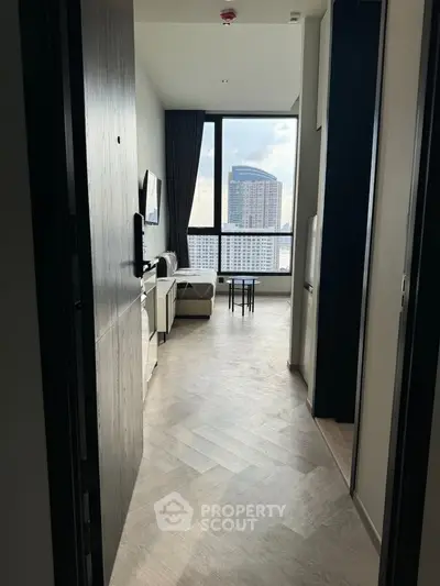 Modern apartment entrance with stunning city view and elegant interior design.