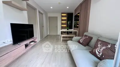 Modern living room with sleek design and cozy sofa, featuring a stylish TV unit and elegant decor.