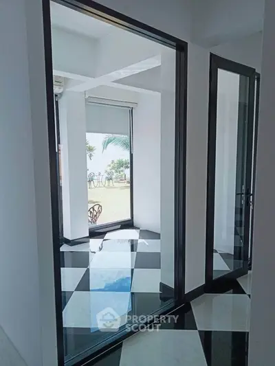 Stunning modern interior with glossy black and white flooring and ocean view