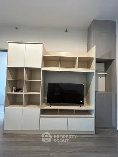 Modern living room with sleek TV unit and ample storage space
