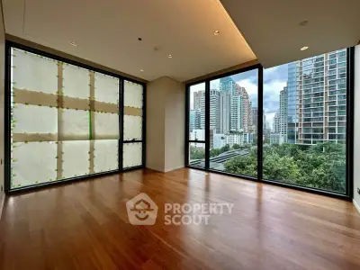 Spacious corner unit with floor-to-ceiling windows offering stunning city views and abundant natural light.