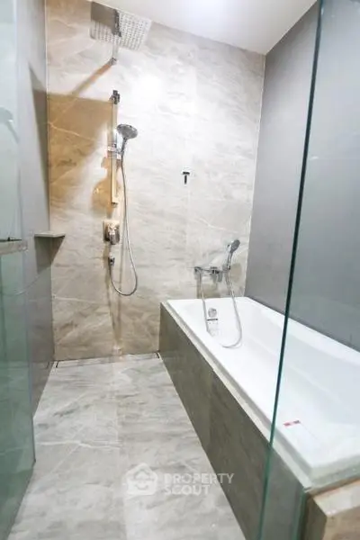 Modern bathroom with elegant marble tiles and a sleek bathtub
