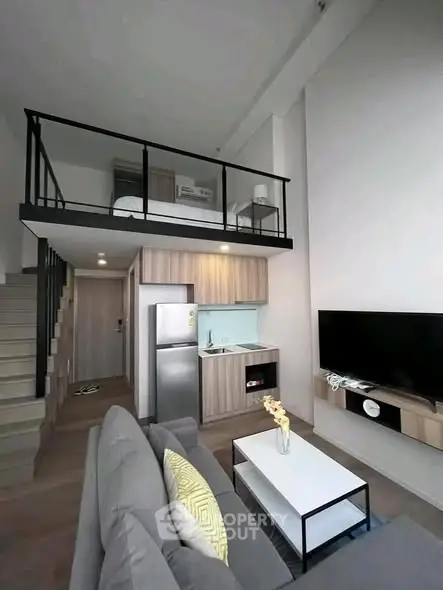 Modern loft apartment with stylish living room and compact kitchen