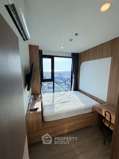 Modern bedroom with city view, featuring a sleek design and ample natural light, perfect for urban living.