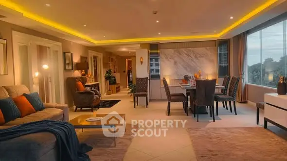 Luxurious open-plan living and dining area with modern decor and large windows.