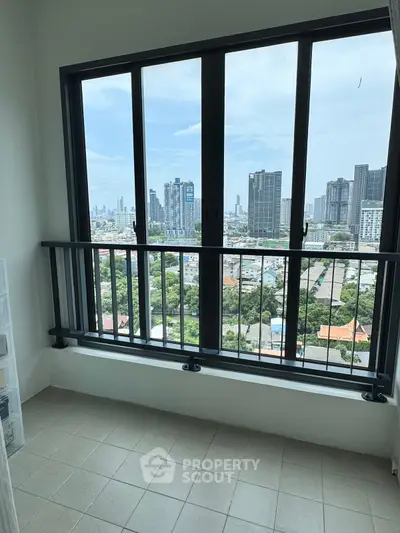 Stunning city view from high-rise balcony with sleek railing and tiled floor.