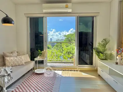 Bright living room with large windows and balcony view, modern decor, and air conditioning.