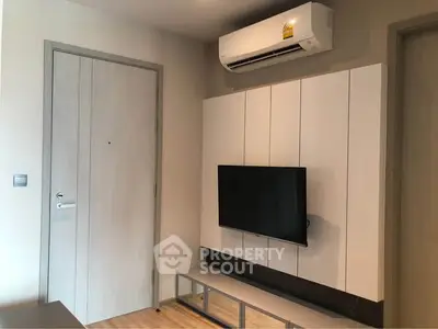 Modern living room with wall-mounted TV and air conditioning unit