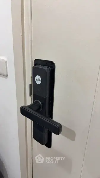 Modern digital door lock on a white door, showcasing advanced security features for contemporary homes.