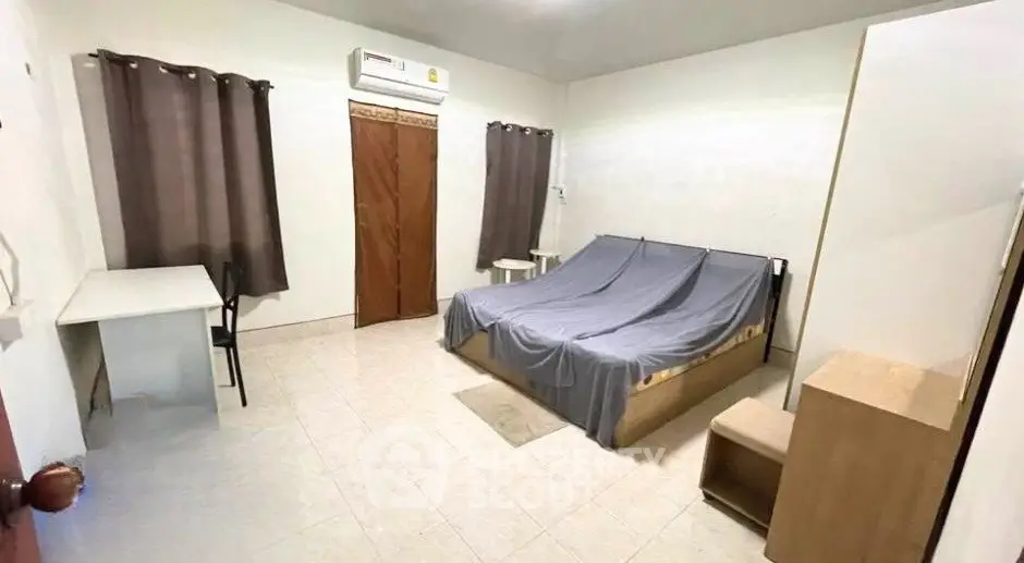 Spacious bedroom with air conditioning and minimalist furniture