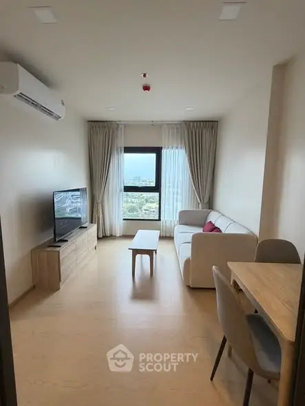 Modern living room with a stunning view, featuring a cozy sofa, TV, and dining area, perfect for relaxation.